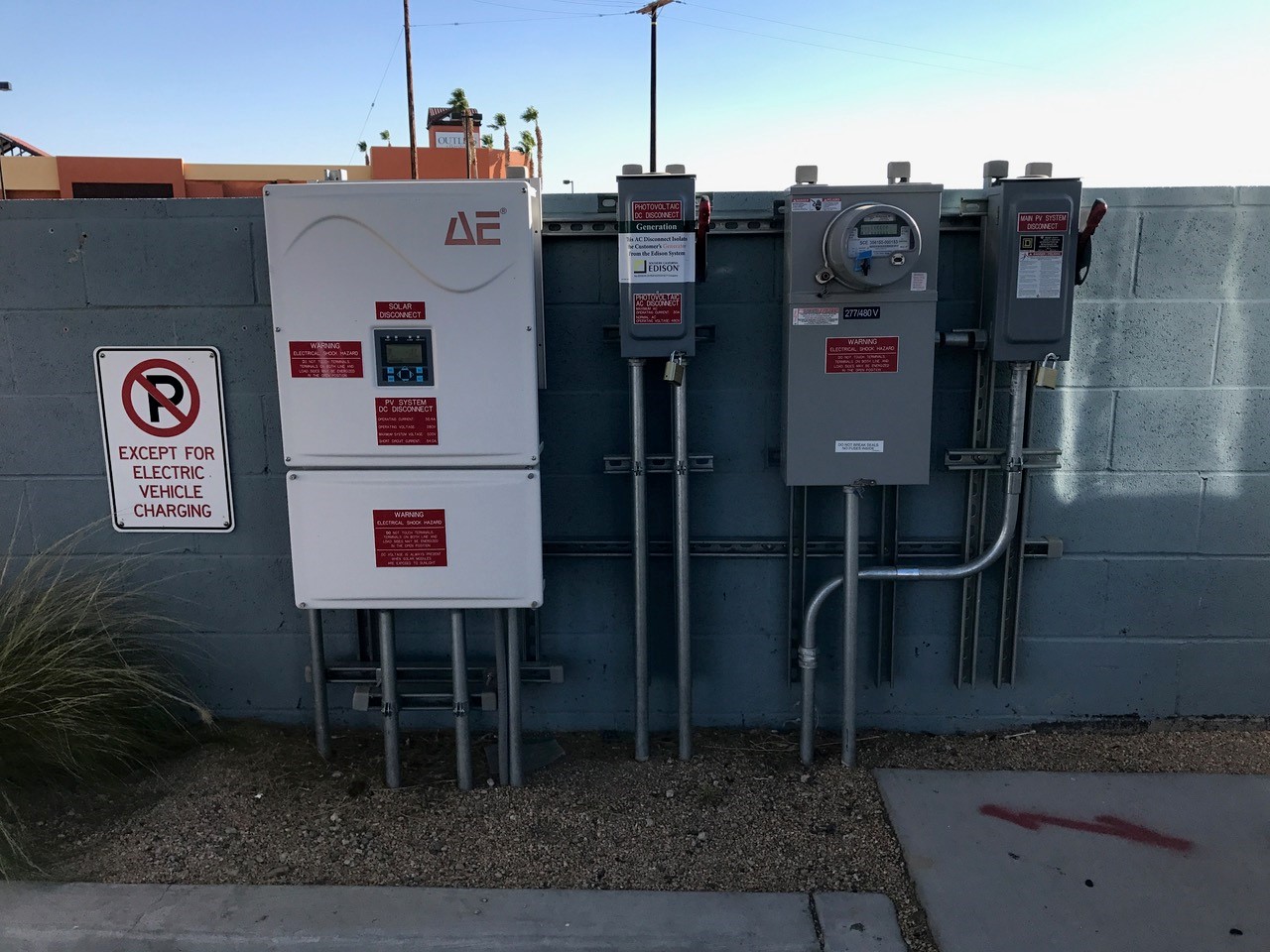 Commercial EV charging infrastructure with electrical panels and utility meters installed by licensed electricians